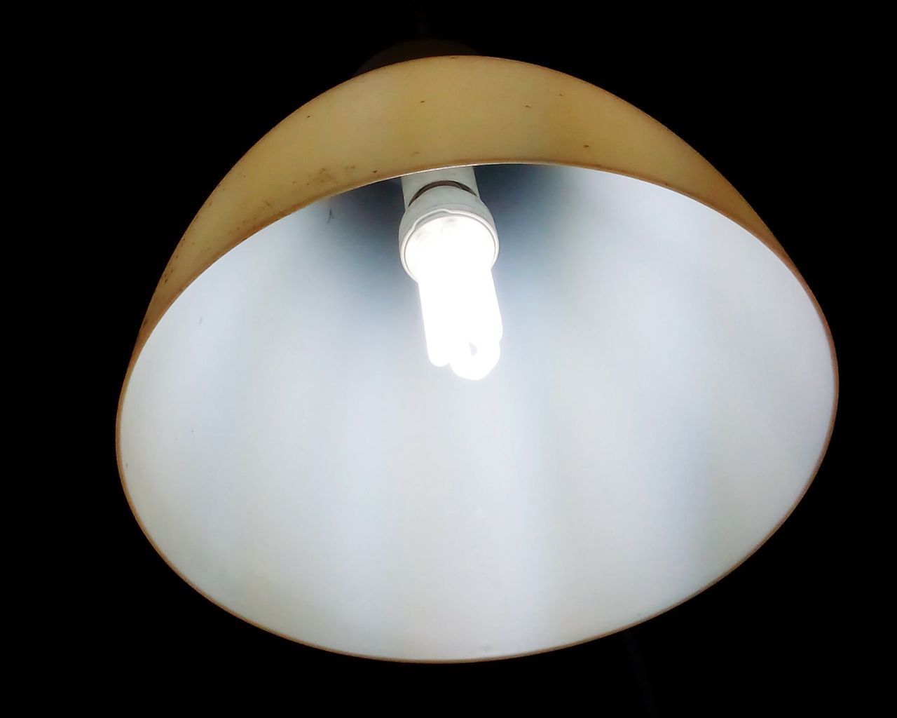 LOW ANGLE VIEW OF ILLUMINATED LAMP AGAINST BLACK BACKGROUND