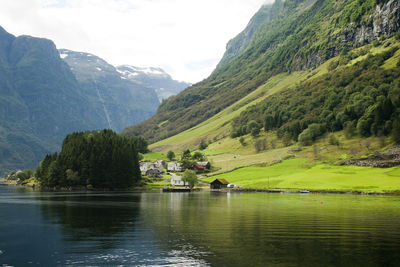 Scenic view of lake and mountains against sky