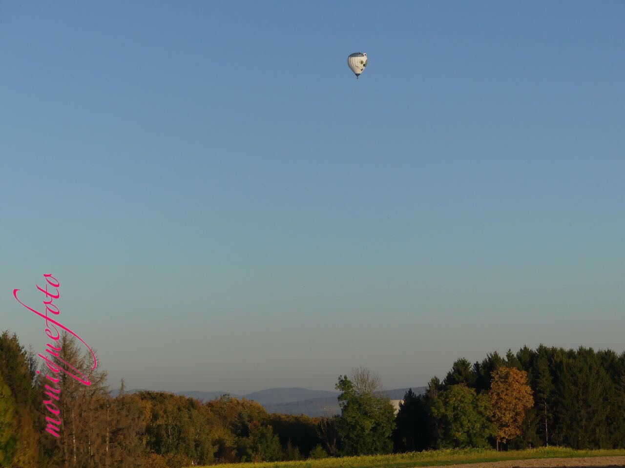 tree, outdoors, clear sky, sky, flying, mid-air, blue, nature, scenics, beauty in nature, day, no people, parachute, paragliding