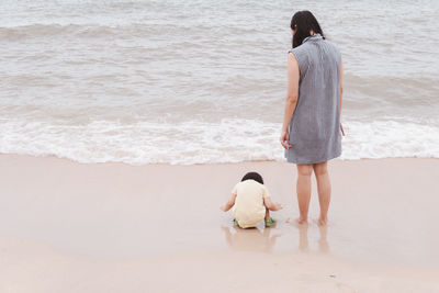 Rear view of women on beach