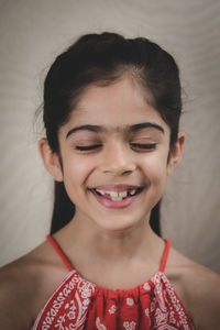 Close-up portrait of a smiling young woman