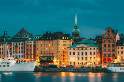 Buildings and harbor against blue sky