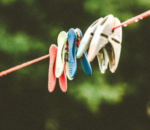 Close-up of shoes hanging on clothesline