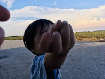 Portrait of boy with hat on road