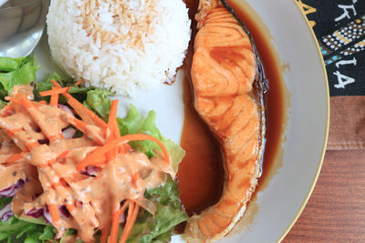 Salmon fish fillet grilled and vegetable salad and jasmine rice.