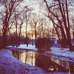 Scenic view of snow covered landscape at sunset