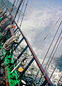 Close-up of boat sailing on sea against sky