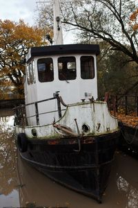 Abandoned boat moored on lake
