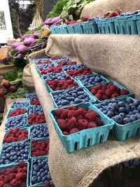 Midsection of man with fruits at market stall