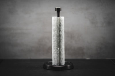 Close-up of metal on table against wall