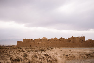 Old building on field against sky