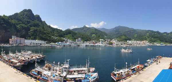 Boats moored in sea against sky