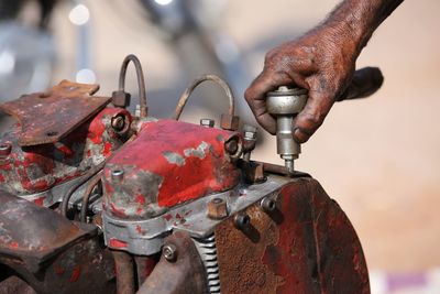 Close-up of man working on rusty metal