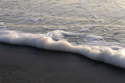 High angle view of waves rushing towards shore