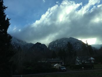 Scenic view of mountains against cloudy sky