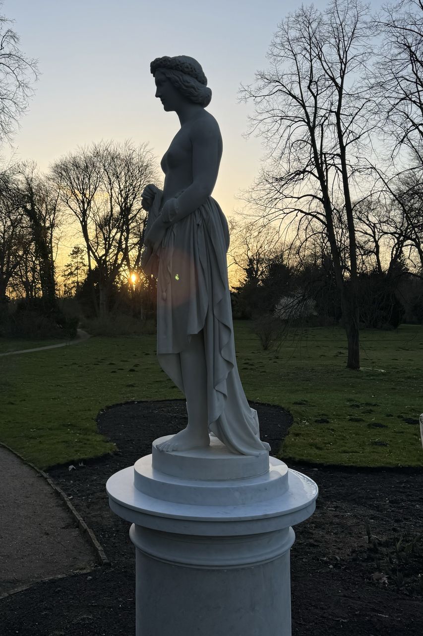 sculpture, statue, human representation, tree, sky, representation, plant, nature, bare tree, art, no people, park, monument, creativity, park - man made space, male likeness, craft, architecture, outdoors, grave, memorial, grass, cemetery, sunset, day