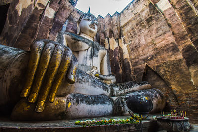 Sukhothai historical park thailand traveller with ancient buddha statue at wat si chum temple.