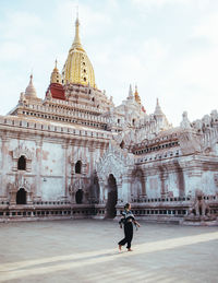 Woman walking against temple