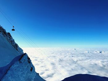 Scenic view of snowcapped mountains against clear blue sky