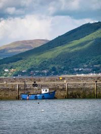 Scenic view of mountains against cloudy sky