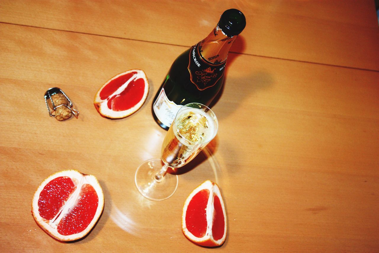 indoors, red, still life, high angle view, table, fashion, close-up, wall - building feature, flooring, communication, no people, shoe, directly above, shadow, wood - material, hanging, text, floor, footwear, single object