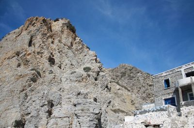 Low angle view of mountain against blue sky