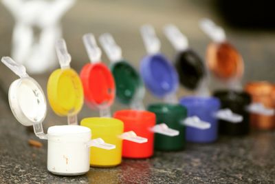 Close-up of colorful watercolor paints in containers on table