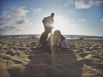 View of man playing with sand on beach