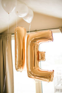 Golden balloons of the bride and groom blown with helium.