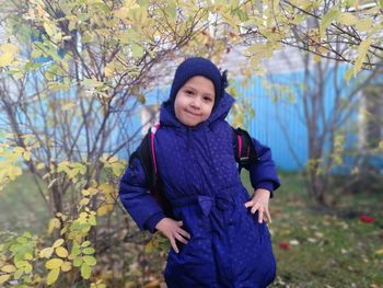 Portrait of cute girl standing on land during winter