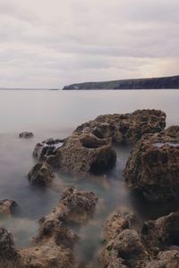Scenic view of sea against cloudy sky