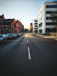 Vehicles on road along buildings