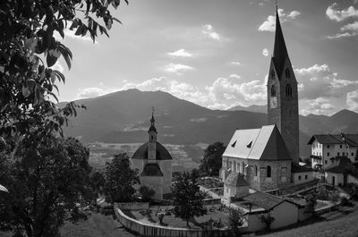 Panoramic view of buildings and trees against sky