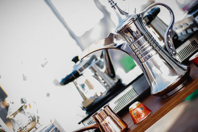Close-up of metal jug on table in kitchen