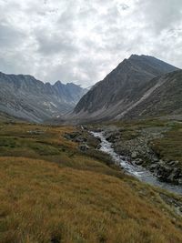 Scenic view of mountains against cloudy sky