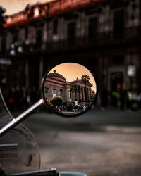 Reflection of building on side-view mirror