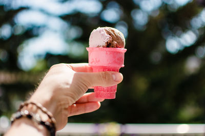 Close-up of hand holding ice cream