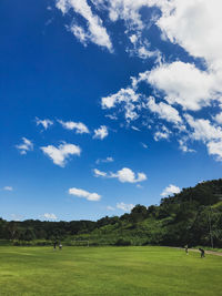 Scenic view of golf course against sky