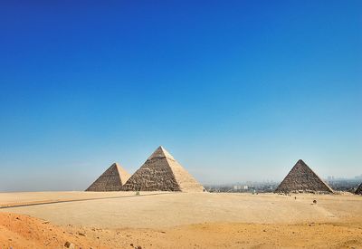 Scenic view of pyramids against clear sky