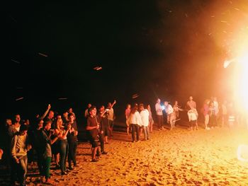 Crowd standing on people at night