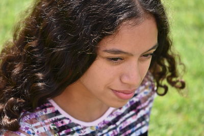 Close-up of smiling teenage girl looking away