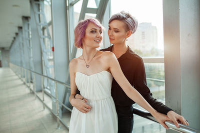 Lesbian couple standing on bridge