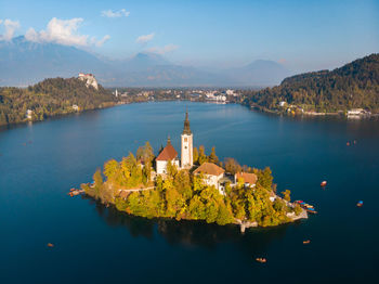 High angle view of lake amidst buildings against sky