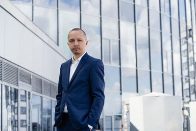 Man standing in front of office building