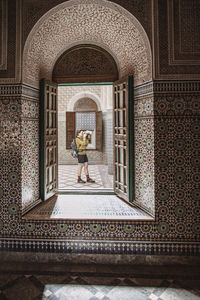 A female tourist takes a picture inside the casbah in telouet, morocco