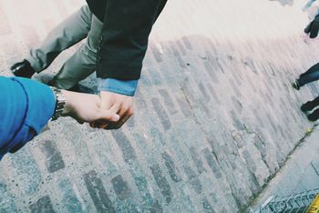 High angle view of couple holding hands on street