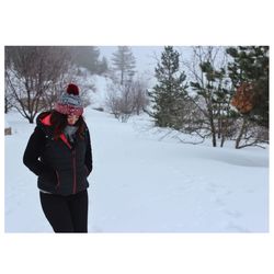 Rear view of man on snow covered trees