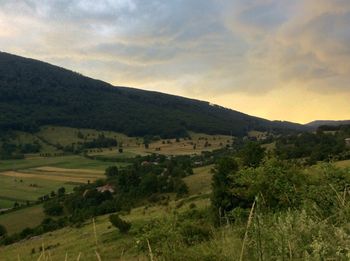 Scenic view of landscape against cloudy sky