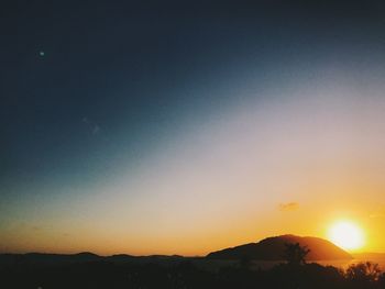 Scenic view of silhouette landscape against clear sky during sunset