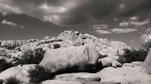 Rain clouds looming over a sea of boulders.